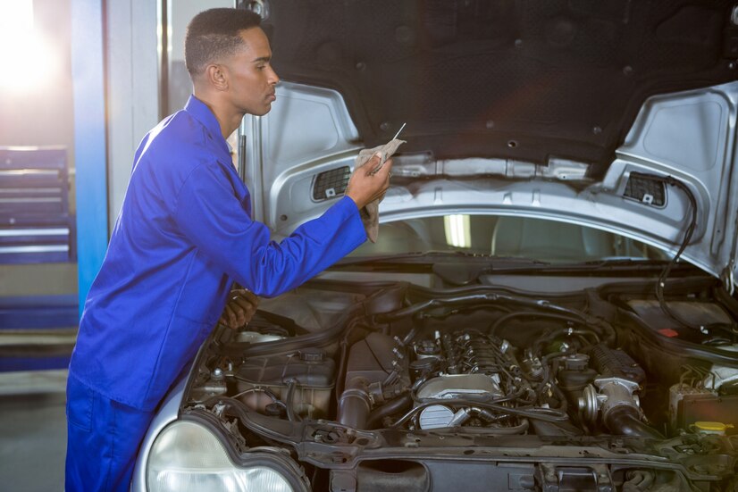 mechanic-wiping-dipstick-with-napkin Mechanic wiping dipstick with napkin